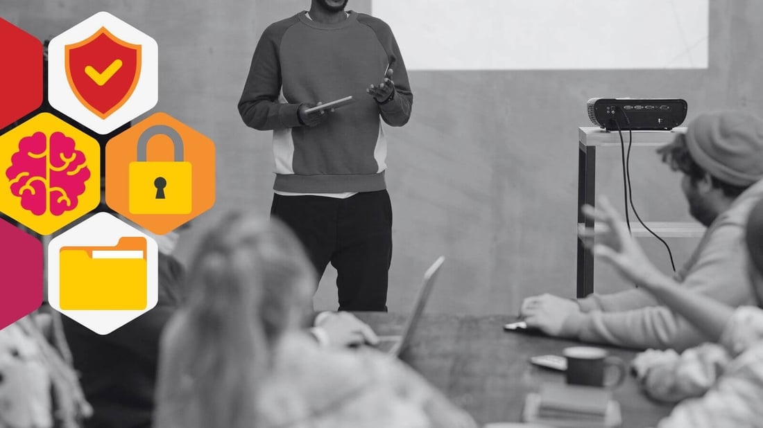 Blog header featuring a man leading a presentation to his employees on insider threats