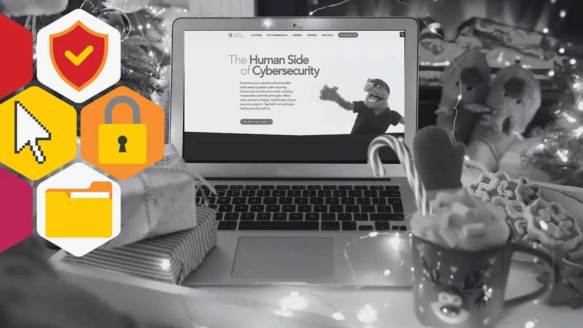 Blog header depicting a christmas scene in the foreground, twinkling lights, hot chocolate, and candy canes. In the background is a laptop opened to Cybermaniacs home page. 