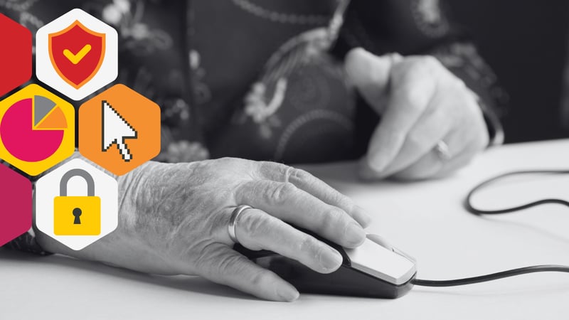 an elderly woman's hands operate a computer mouse
