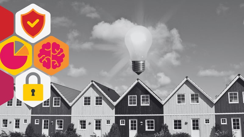 a row of houses, one has a lit lightbulb above it